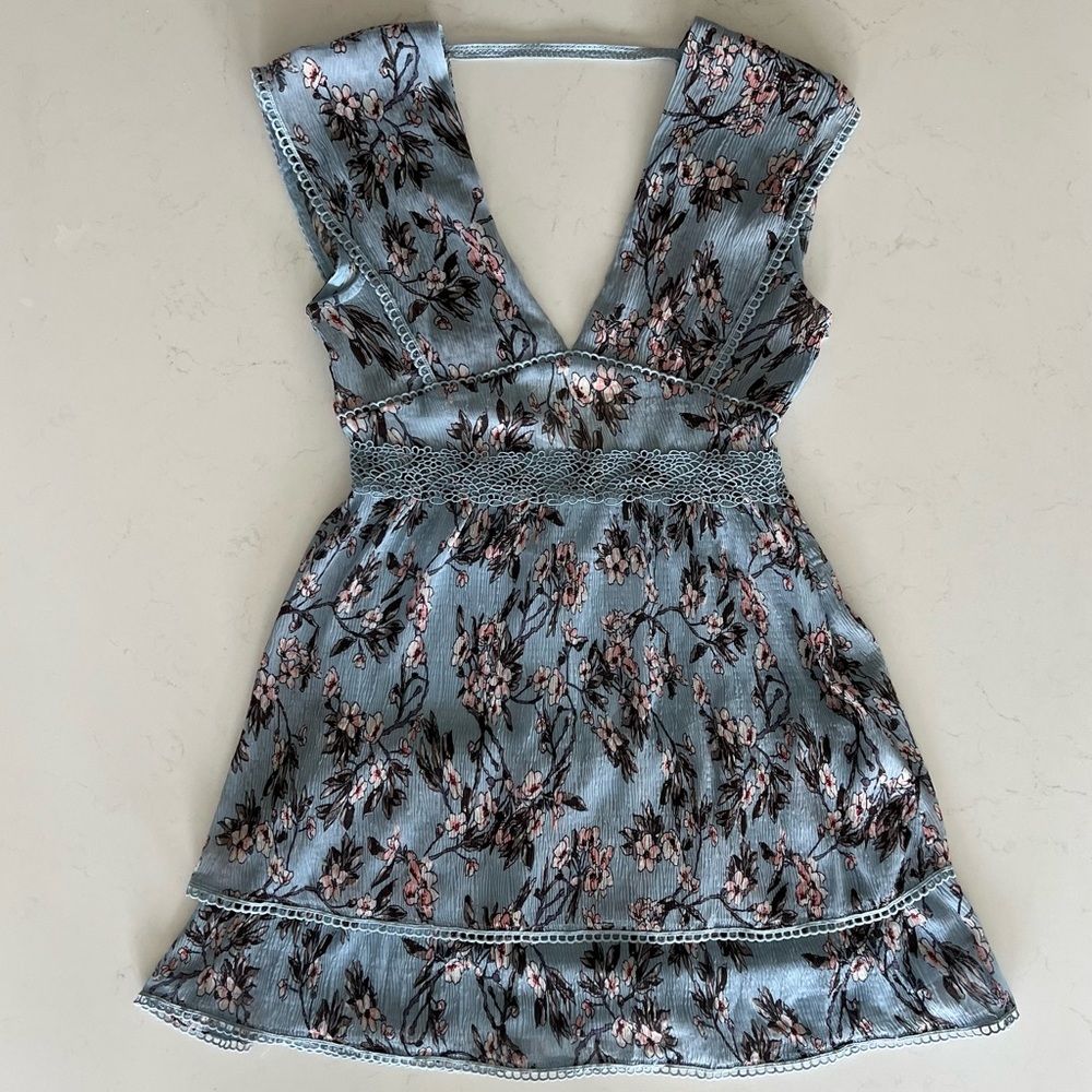 Fun, flirty summer dress with plunging neckline in light blue floral print.